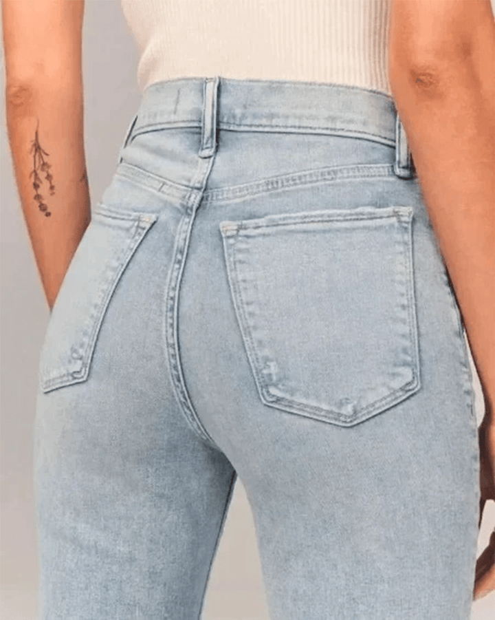 Retro-style women's flared denim jeans, featuring a chic high-waist and comfortable stretch in blue.