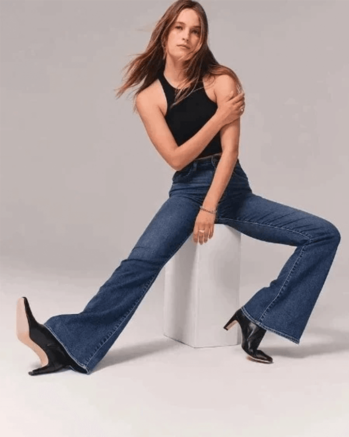 High-waisted blue denim flared jeans for women, a fashion-forward choice with a comfortable, flattering fit.