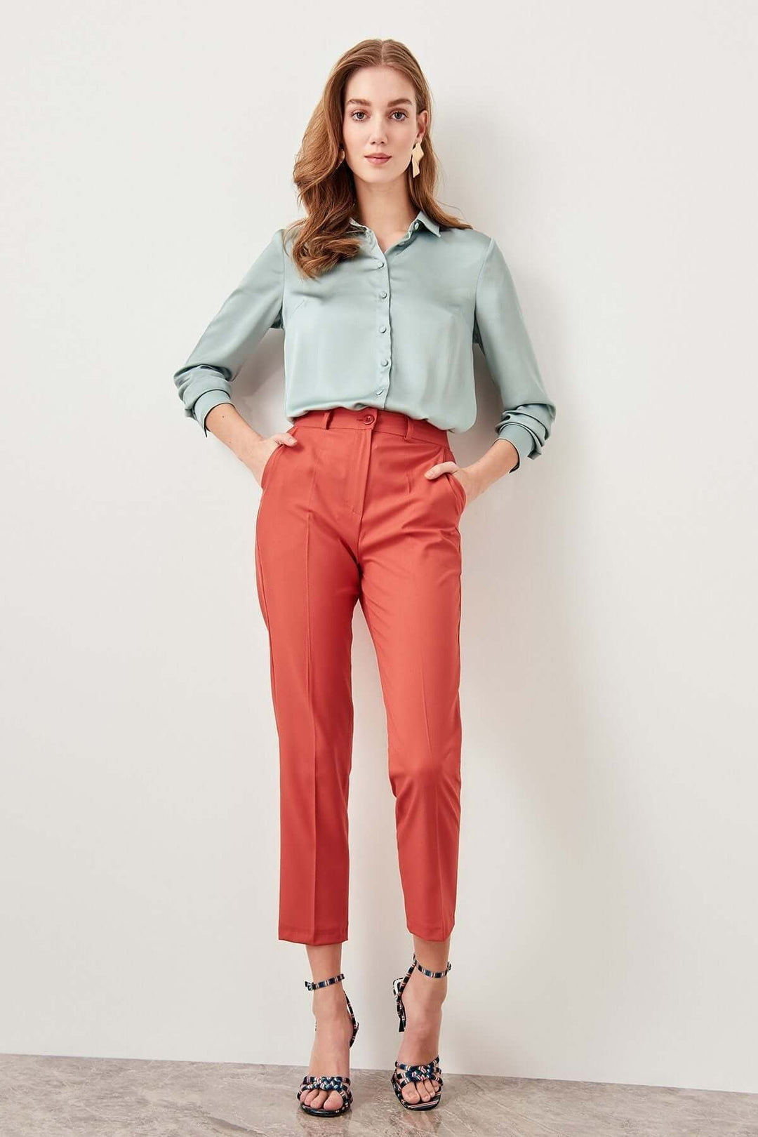 Chic orange high-waisted relaxed fit polyester trousers, perfect for versatile women's everyday fashion.