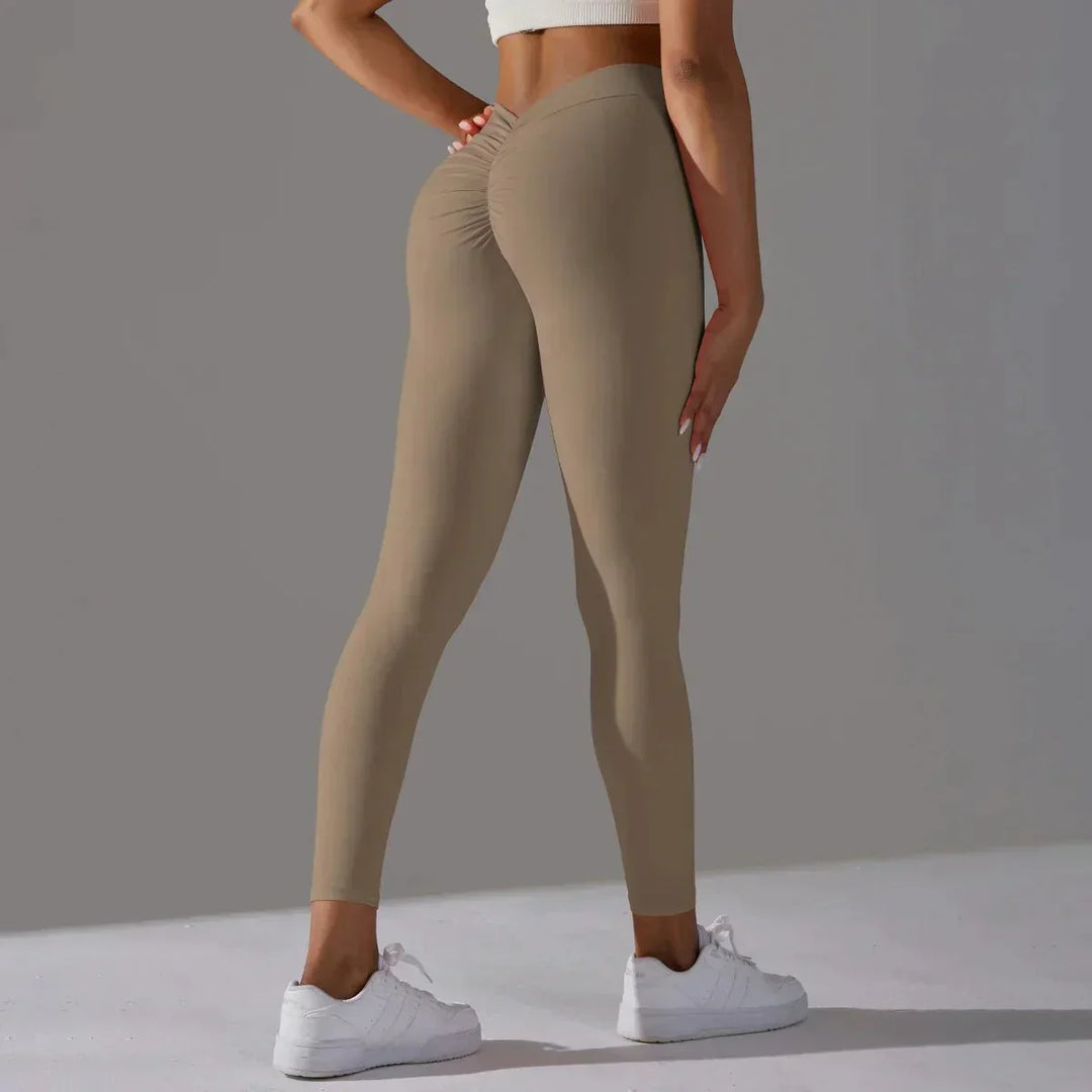 Performance women's workout leggings with scrunch detail & compression for active fitness.