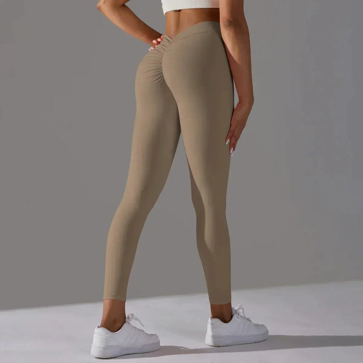 Performance women's workout leggings with scrunch detail & compression for active fitness.