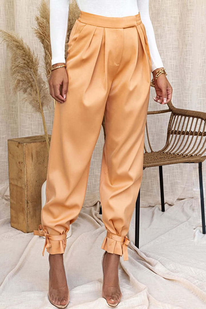 Chic high-waisted tapered pants for women, featuring ankle ties. Ideal for office wear or casual outings.