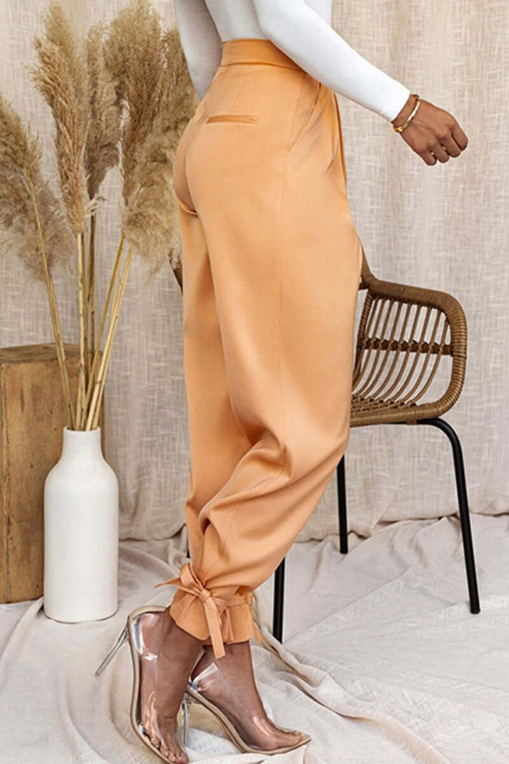 Versatile women's high-waisted tapered pants with ankle ties, easily dressed up for work or down for casual.