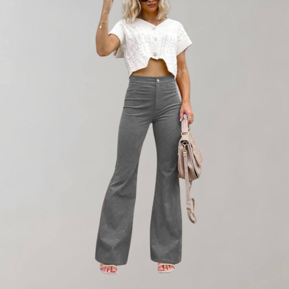 Woman walking in flowy high-waisted wide leg trousers, highlighting their comfortable movement and stylish drape.