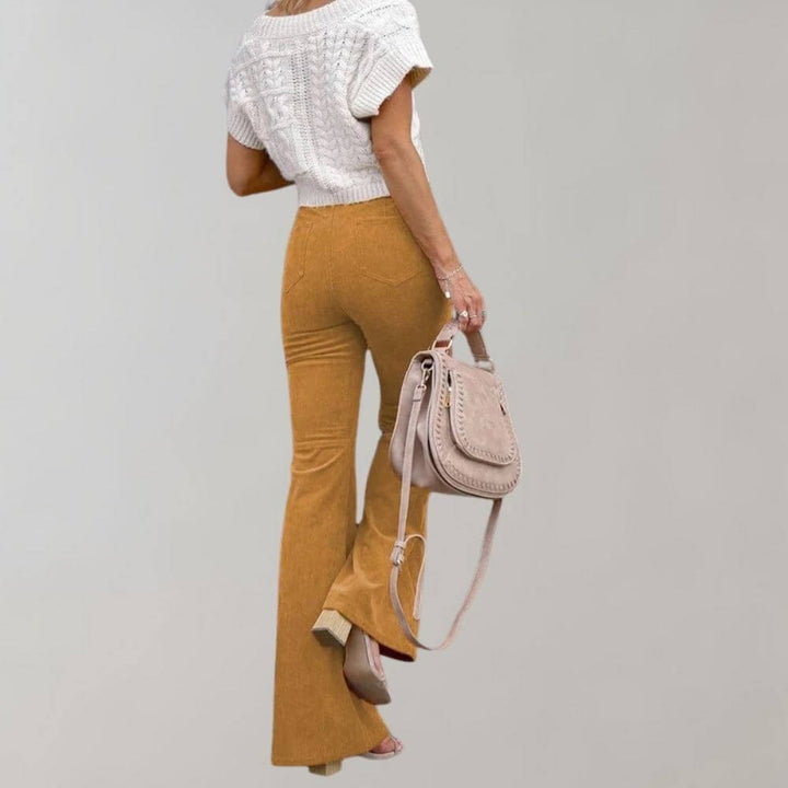 Women's high-waisted wide leg trousers paired with a blouse, showcasing elegant and versatile fashion.