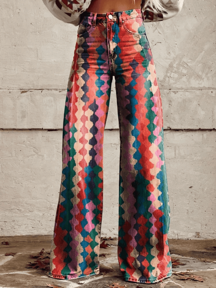 Women's high-waisted wide-leg trousers with vibrant retro geometric print, ideal for vintage boho style.