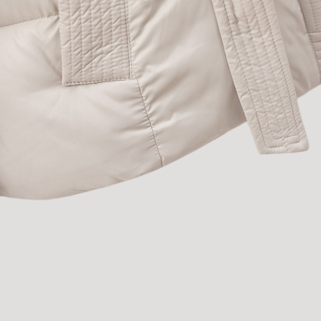 Stylish women's belted puffer winter coat. Hooded, warm outerwear for a fashionable look.