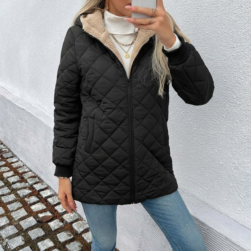 Cozy women's longline puffer coat. Features a warm quilted design and hood, perfect for cold winter days.