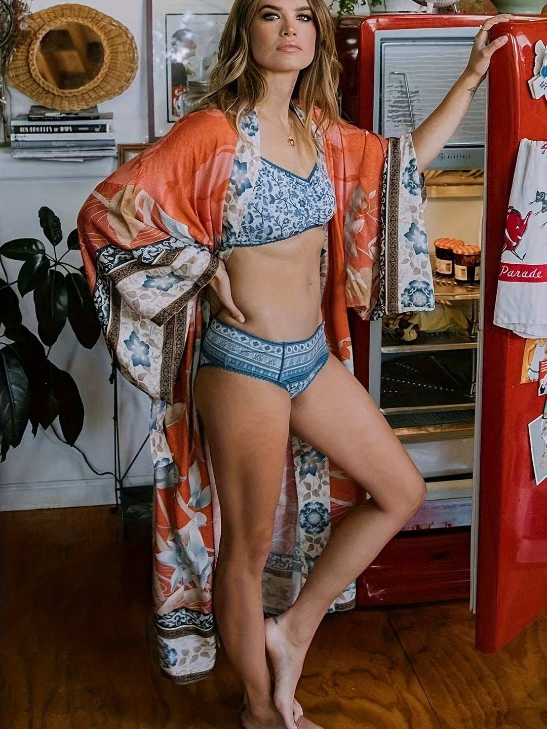 Red floral print kimono for women, featuring a flowing open front and batwing sleeves, perfect for resort.