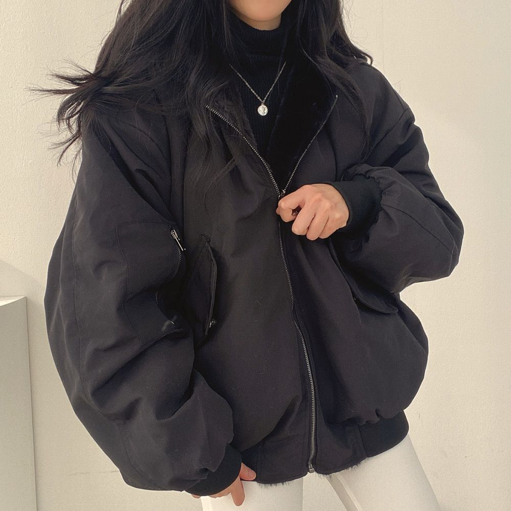 Fabric detail on women's reversible winter jacket, durable cold weather outerwear.