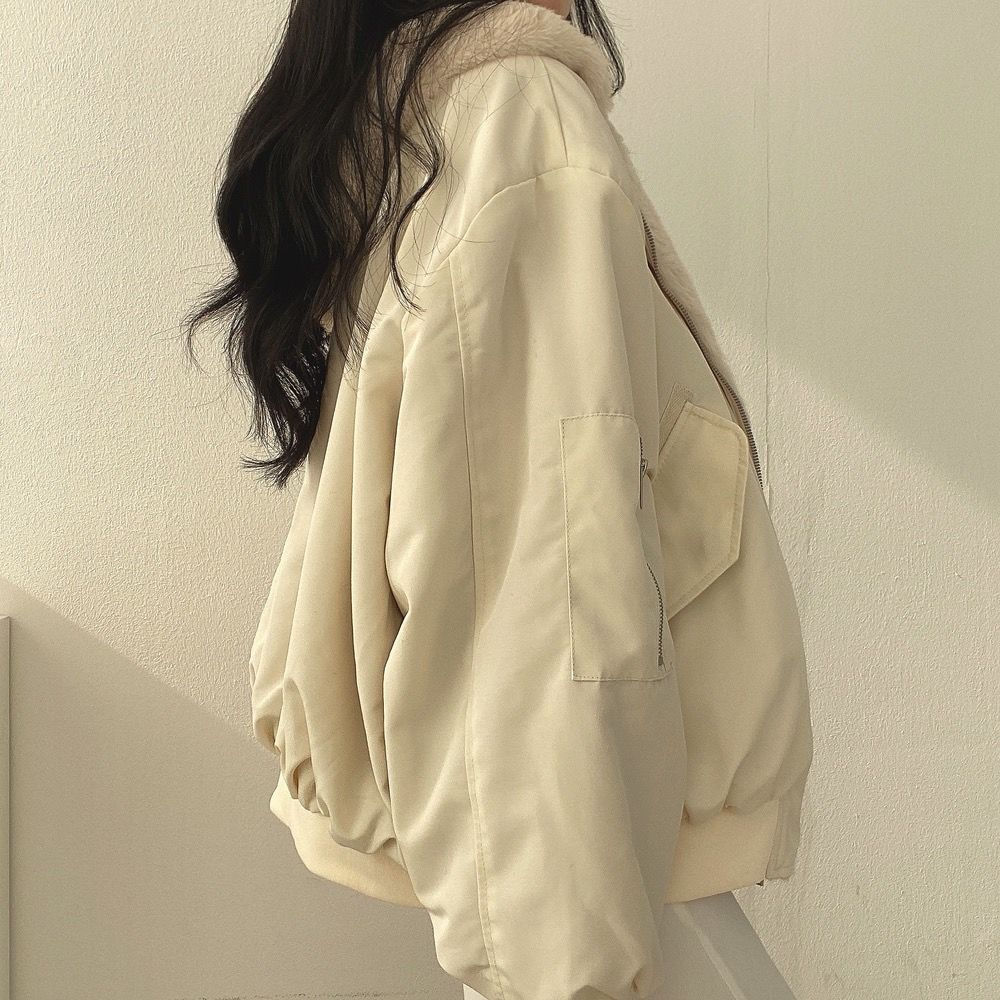Model wearing women's Isla reversible winter coat, showcasing versatile fashion & warmth.