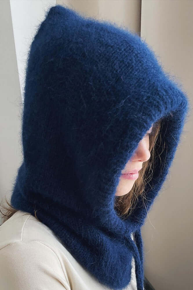 Close-up of a soft knitted women's balaclava hood, a warm and cozy winter headwear scarf accessory.