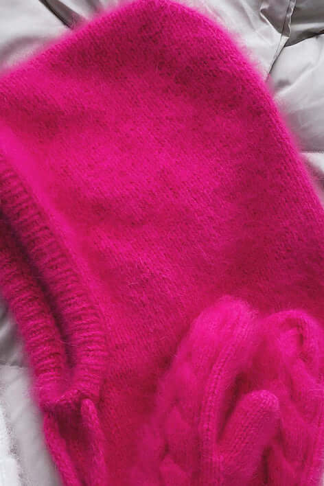 Warm knitted women's balaclava hood for winter sports. Cozy headwear scarf for cold weather fashion.