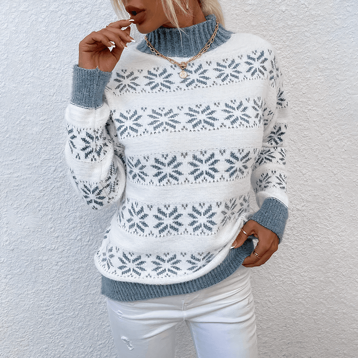 Soft women's turtleneck sweater with a charming knitted snowflake design, ensuring comfort in cold weather.