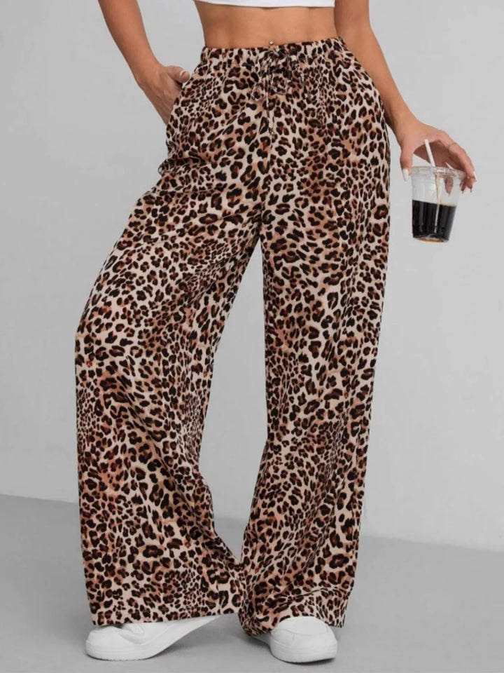 Casual women's leopard print wide leg pants, ideal for vacation wear. Features a comfortable drawstring waist.