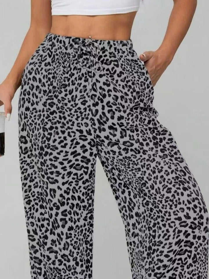 Comfortable women's wide leg pants featuring a vibrant leopard print and an adjustable drawstring waist.