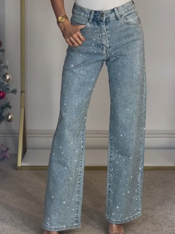 Women's light blue high waist straight leg jeans with sparkling diamanté details on the pockets, stylish denim fashion.