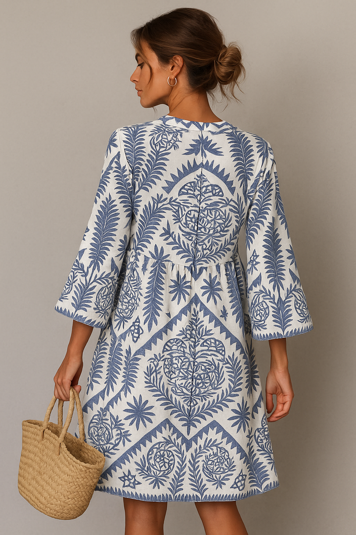 Flowy women's summer midi dress with a V-neck and vibrant boho pattern, ideal for casual wear or vacation.