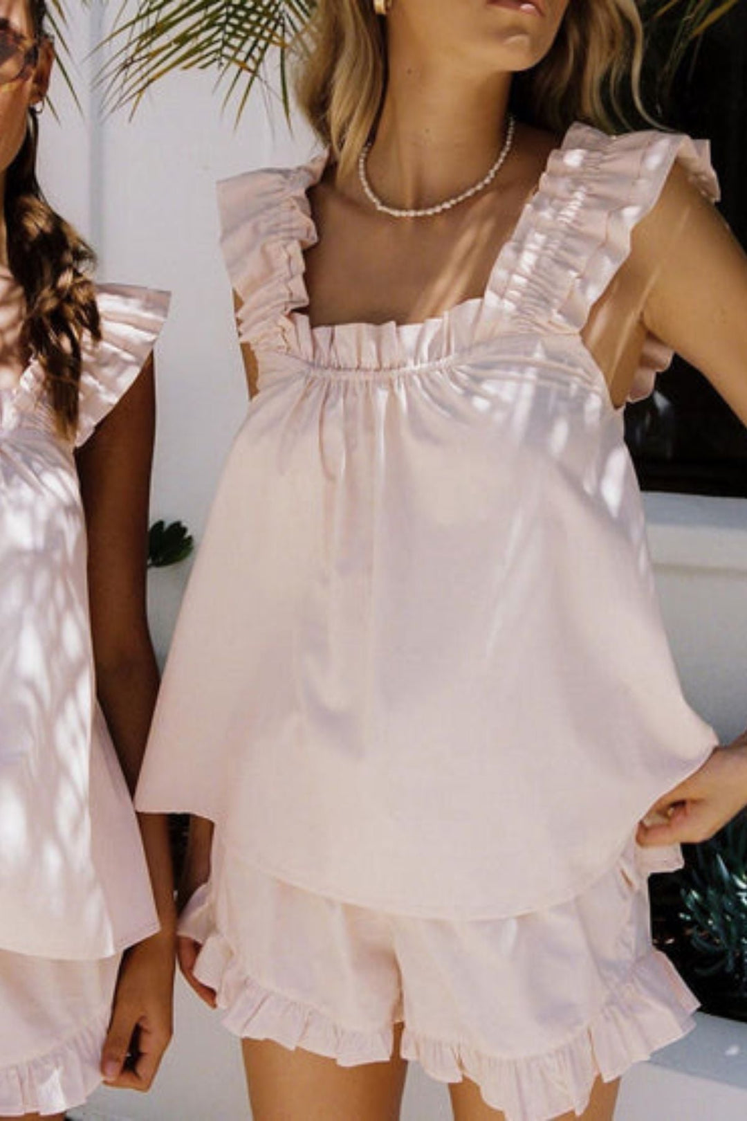 Soft, comfortable women's summer pajama set with ruffles. Lightweight home wear, sleeveless top & shorts for relaxed lounging.