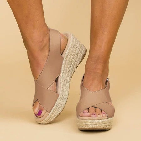 Women's lightweight summer sandals with open toe and adjustable strap in a light color, perfect for beachwear.