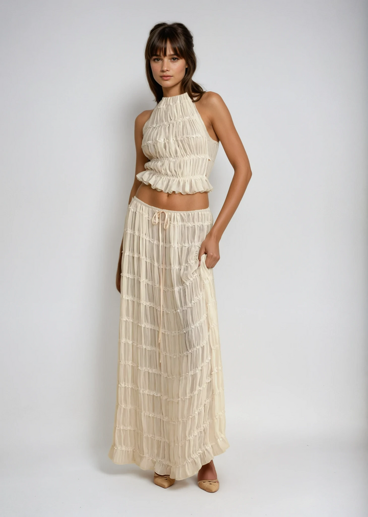 Women's lightweight two-piece summer outfit featuring a flowy halter top & maxi skirt, perfect for vacation.