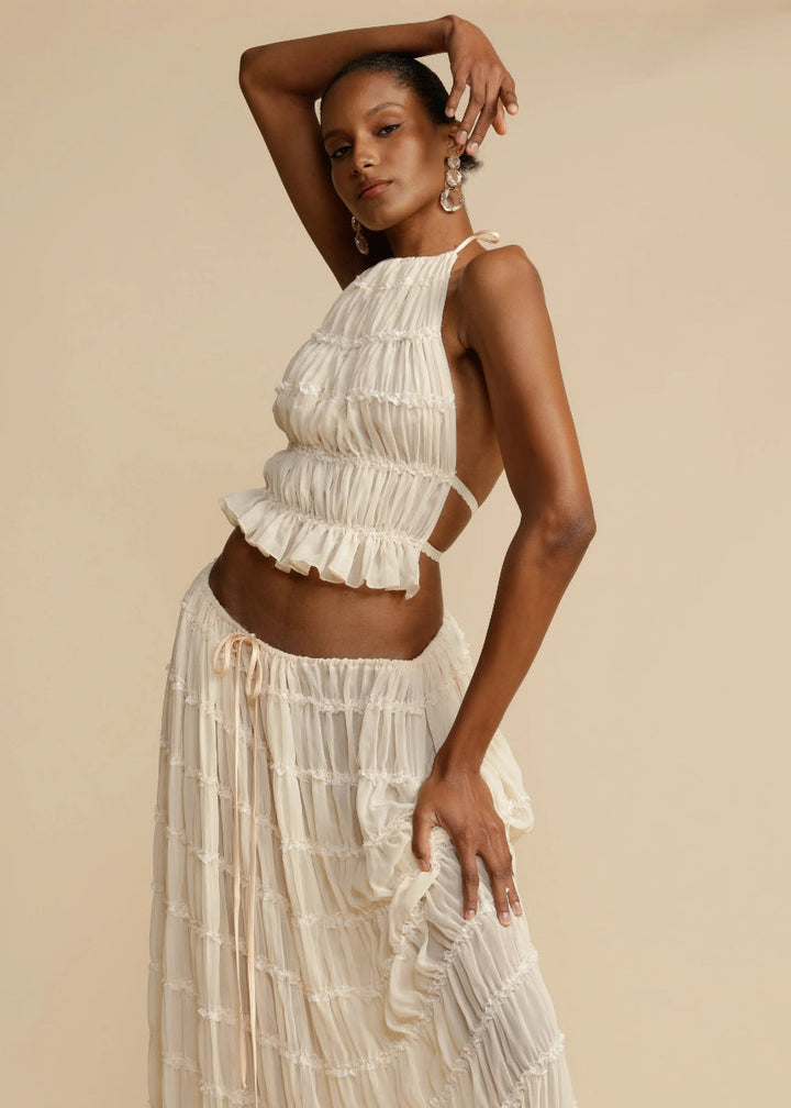 Breathable women's summer two-piece set with a stylish halter top and a comfortable flowy maxi skirt.