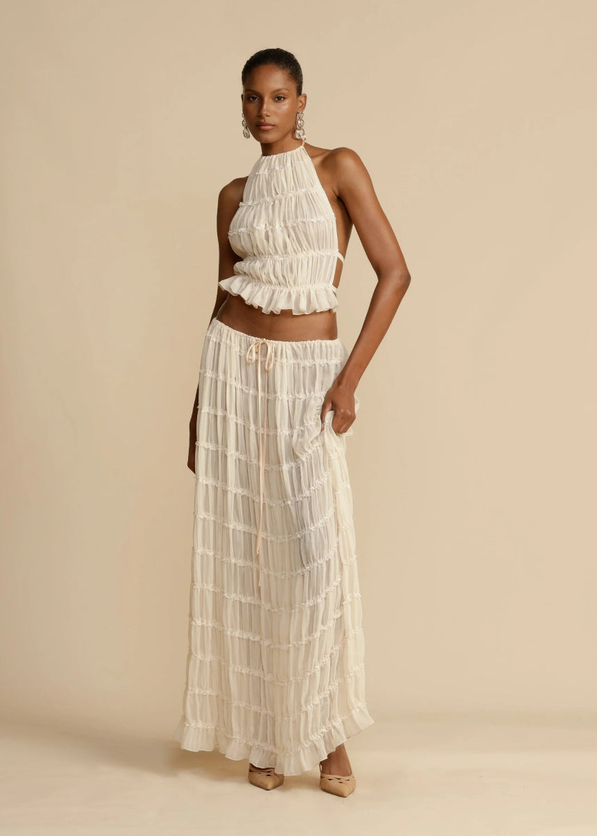 Elegant women's two-piece beachwear outfit: lightweight halter crop top and a long, flowy maxi skirt.