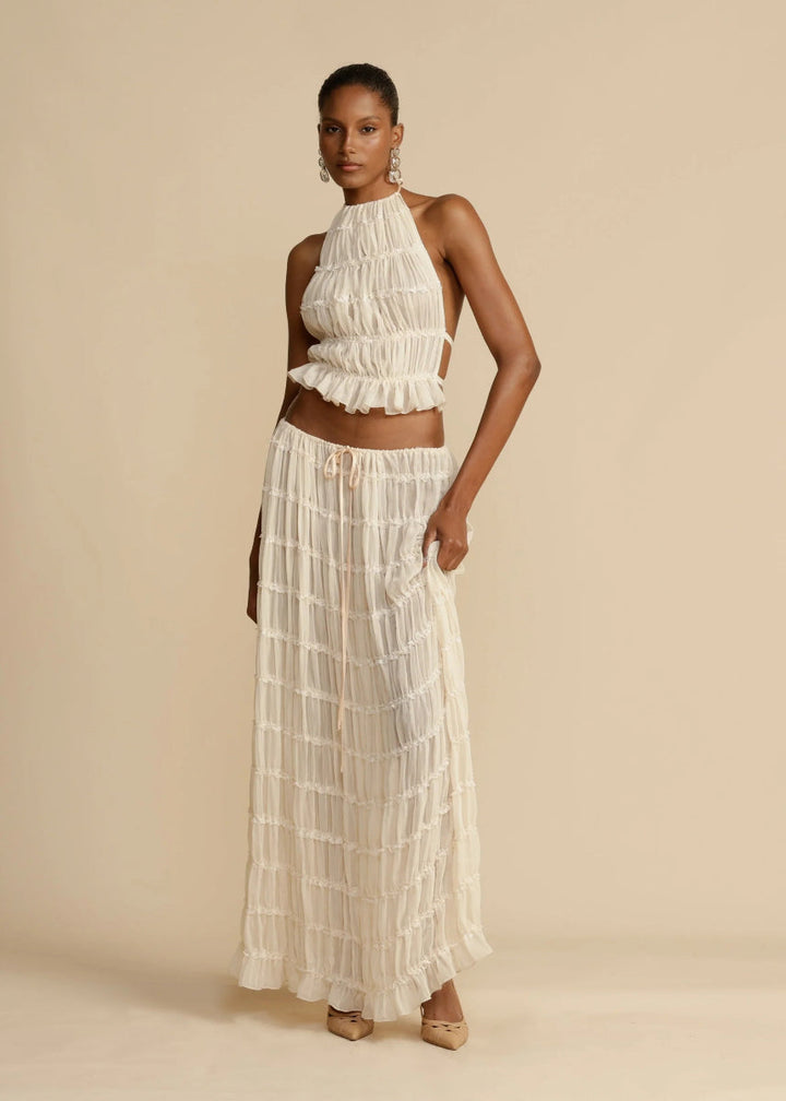 Elegant women's two-piece beachwear outfit: lightweight halter crop top and a long, flowy maxi skirt.