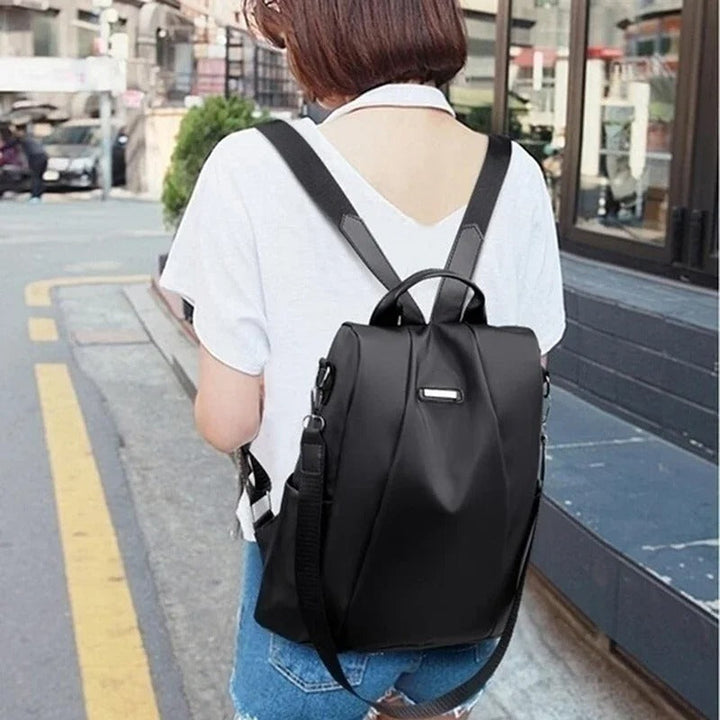 Lightweight water-resistant nylon travel bag for women. Multi-way carry options, perfect for everyday essentials.