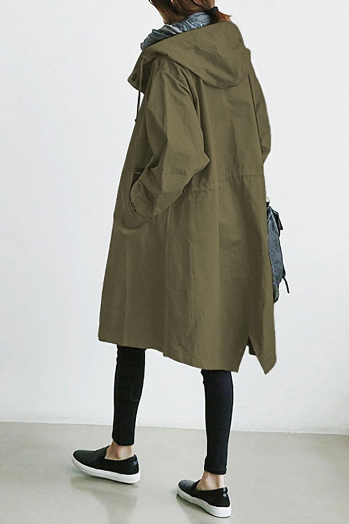 Waterproof women's long rain trench coat with hood, ideal for wet spring and fall weather.