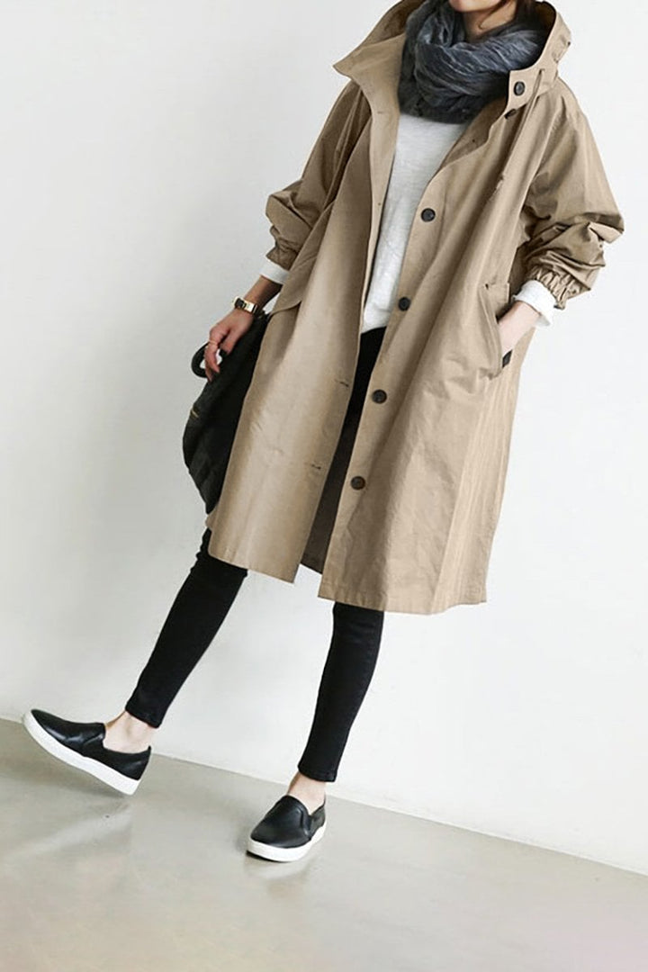 Breathable women's lightweight rain trench coat with hood, offers waterproof protection & comfort.