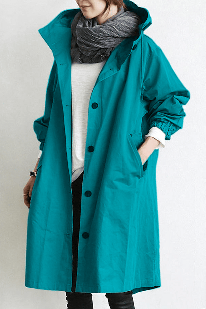 Close-up of lightweight waterproof fabric on a women's hooded rain trench coat, showing detail.