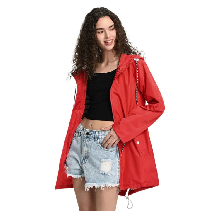 Woman walking in a versatile lightweight waterproof hooded rain jacket, ideal for daily wear & travel.