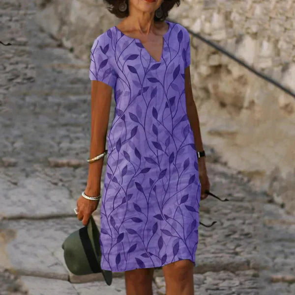 Effortless women's summer mini dress, made from comfortable linen with a stylish leaf print and flattering V-neck cut.