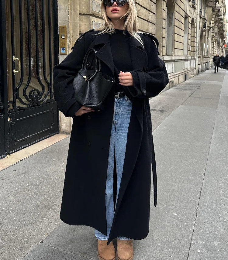 Elegant women's fashion trench coat, a long belted outerwear piece with an oversized fit for style.