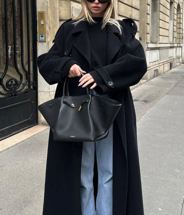 Women's stylish long trench coat, an oversized and belted outerwear classic for fall and spring fashion.