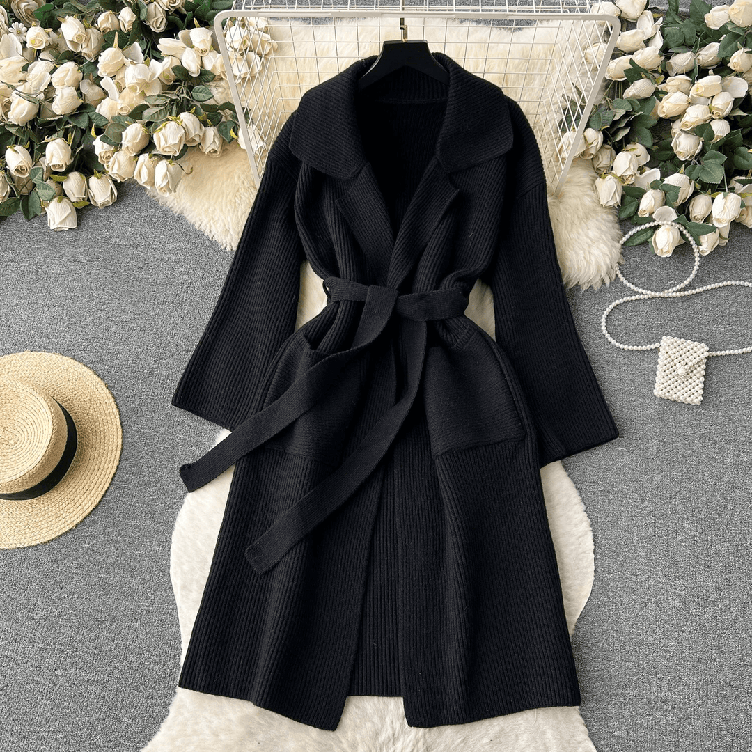 Full-length view of a women's long knit cardigan, emphasizing its flowy design and modern style.