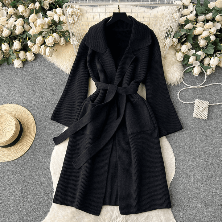 Full-length view of a women's long knit cardigan, emphasizing its flowy design and modern style.