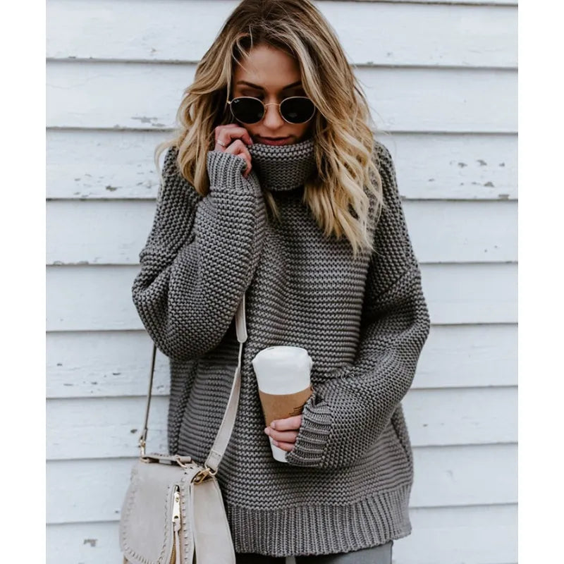 Chic black women's knit turtleneck sweater. Long sleeve, oversized fit. Versatile for winter fashion.