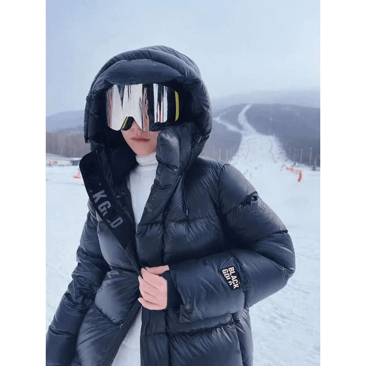 Insulated women's long padded jacket, a warm winter puffer coat. Stylish outerwear for cold weather.