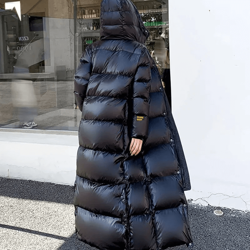 Chic women's long padded jacket. Modern, warm winter coat & insulated puffer for cold weather fashion.