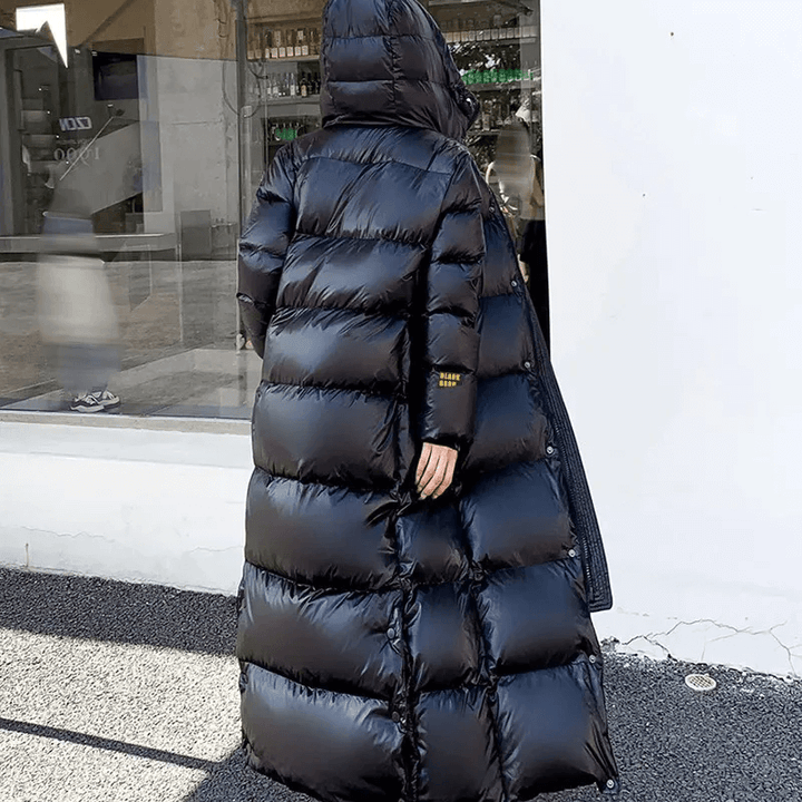 Chic women's long padded jacket. Modern, warm winter coat & insulated puffer for cold weather fashion.
