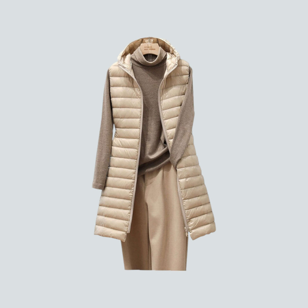Women's long quilted puffer vest in black, perfect for stylish winter layering and staying warm.