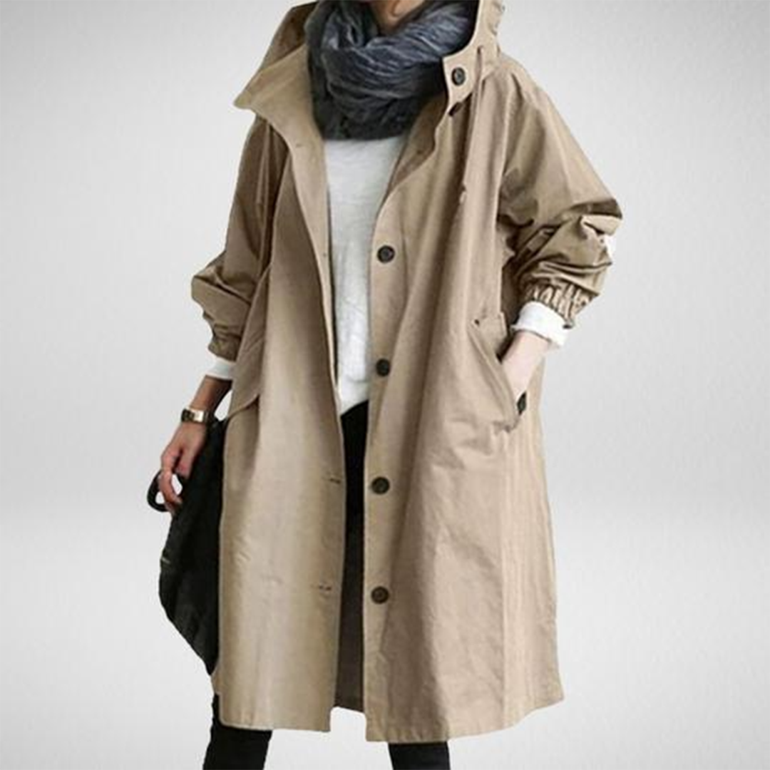 Women's long waterproof raincoat with adjustable hood & functional pockets. Ideal for all-weather protection.