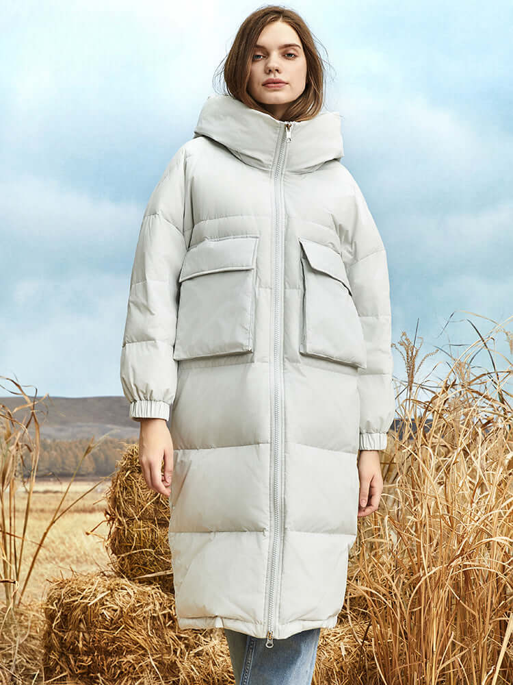 Women's long winter puffer coat with a warm hood, perfect for cold weather protection.