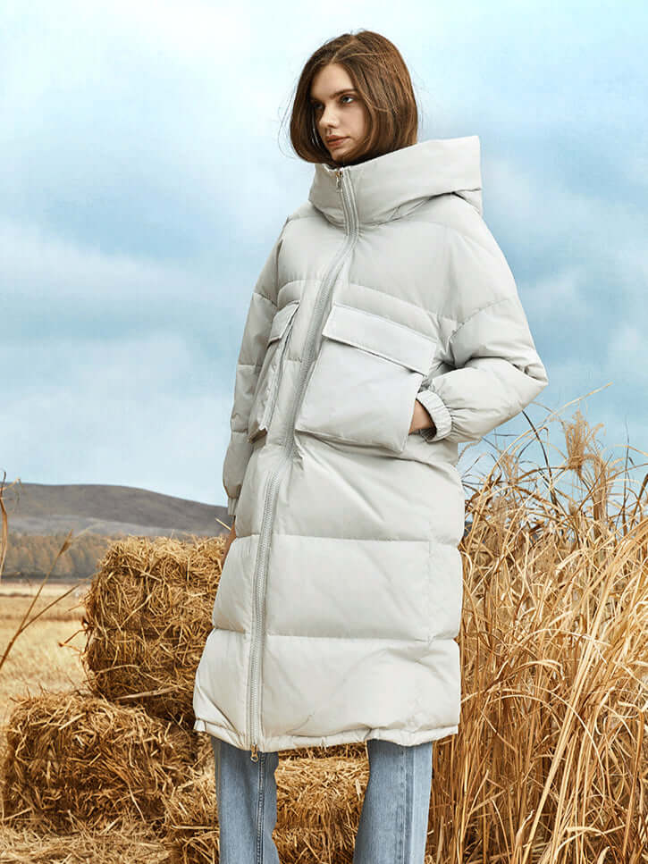 Stylish women's long hooded puffer coat, insulated for ultimate warmth in winter fashion.