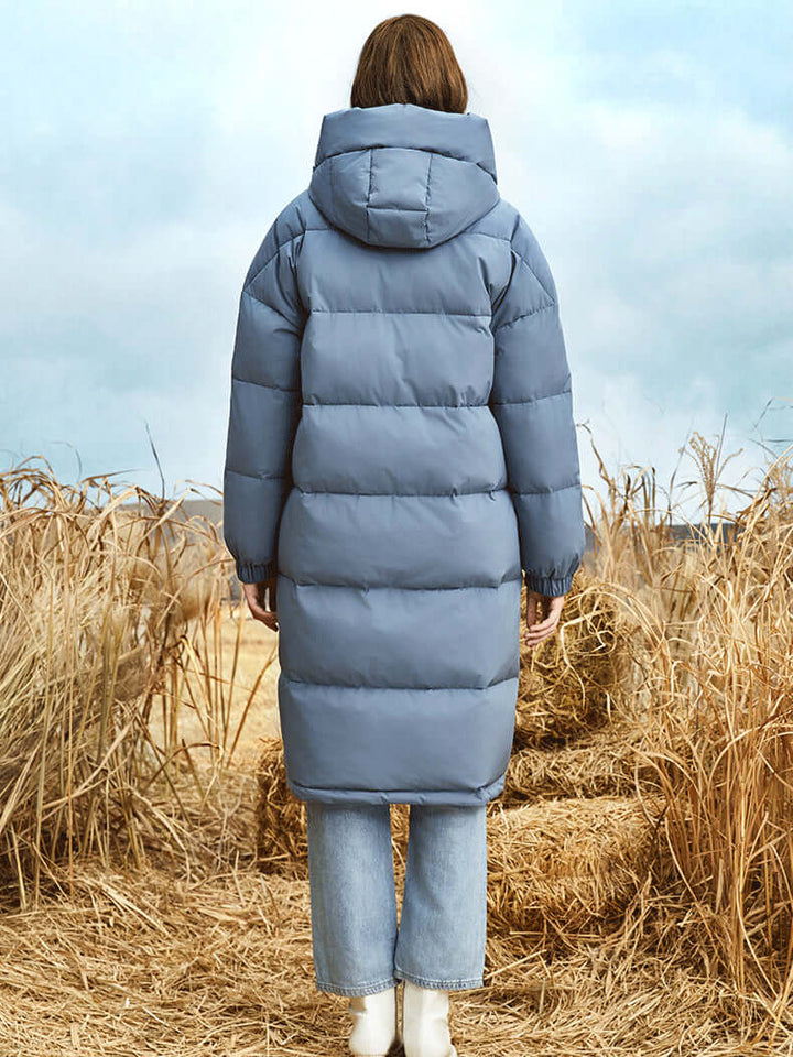 Women's full-length hooded puffer coat, providing warmth and comfort during harsh winter conditions.