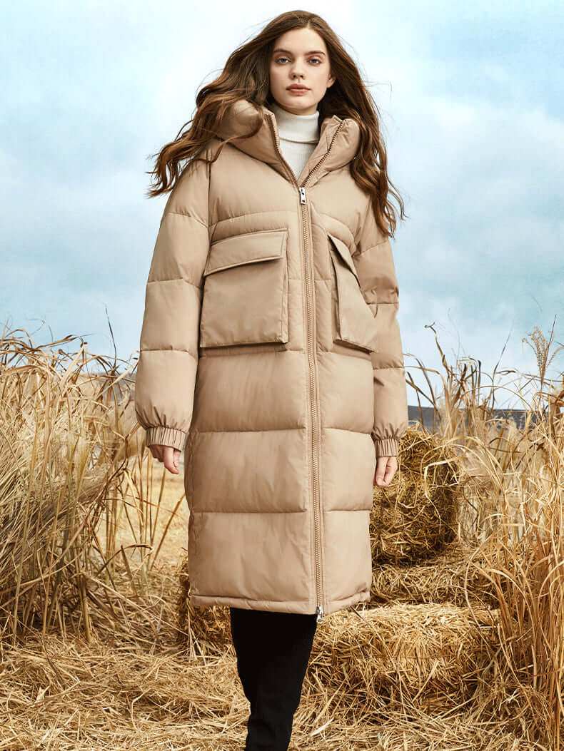 Durable women's long winter puffer coat with hood, protecting against the elements in cold weather.