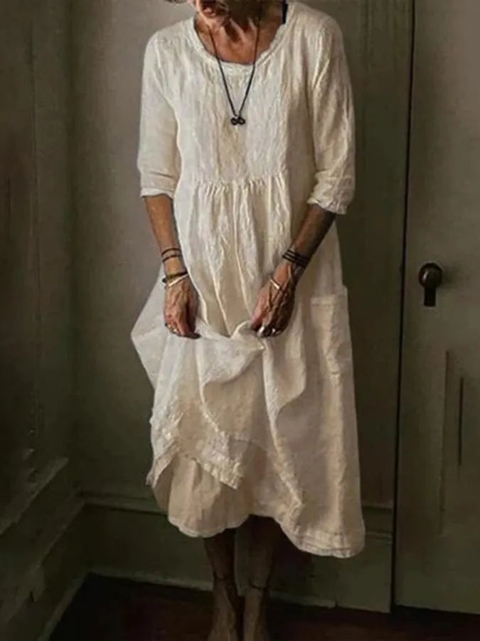 Stylish women's loose fit midi dress, cotton linen blend, featuring an asymmetric hem for casual spring/summer wear.