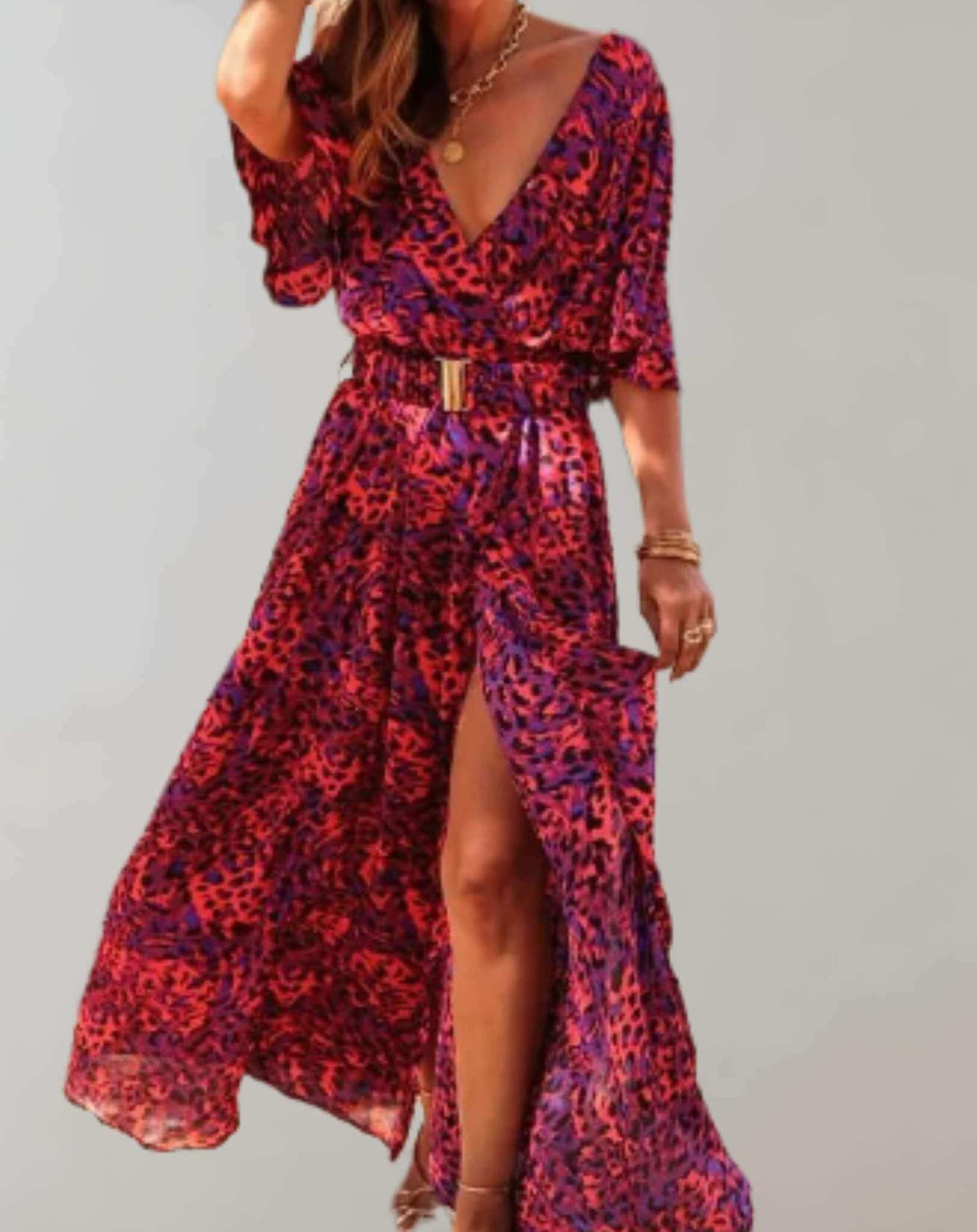 Detailed view of a vibrant floral print on a loose fit women's midi dress with an elegant side slit.